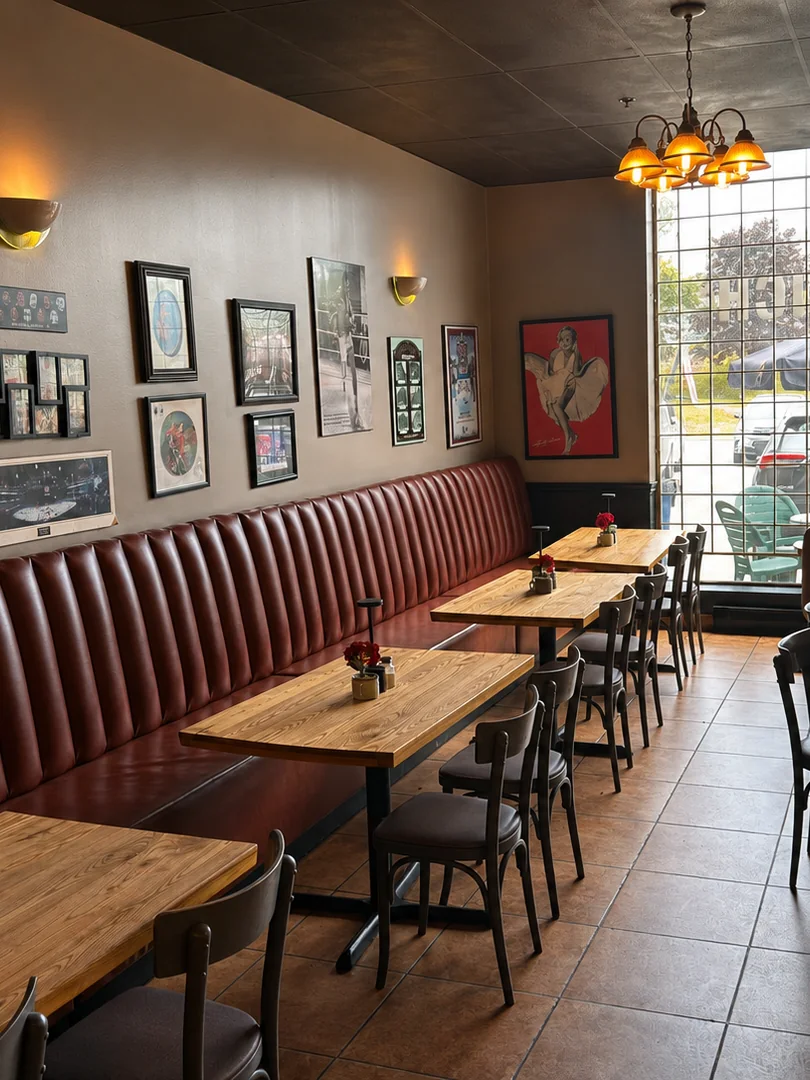 Wooden tables along the burgundy banquette at Smokey's